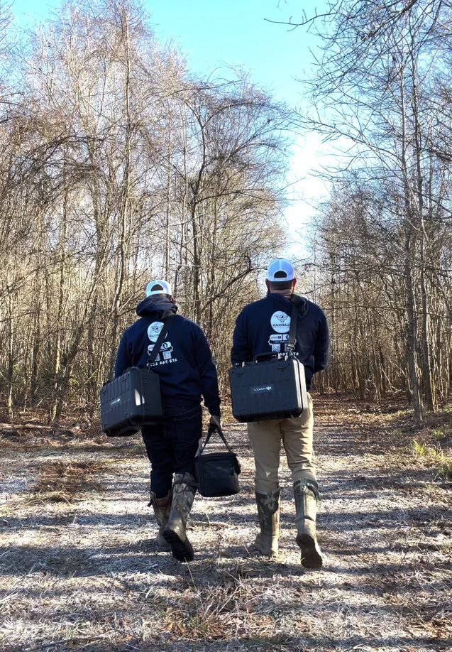 Guardian drone solutions team walking down road with equipment